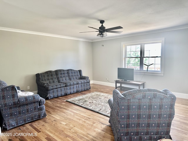 living room with baseboards, wood finished floors, and ornamental molding