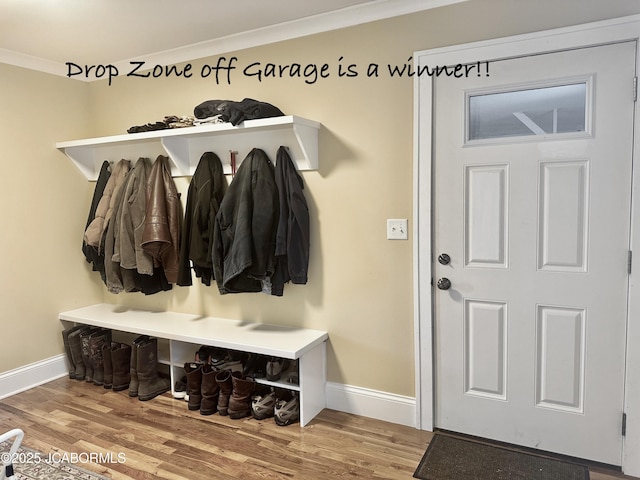 mudroom with baseboards, wood finished floors, and crown molding