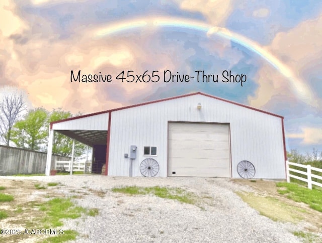 garage with a detached garage and gravel driveway
