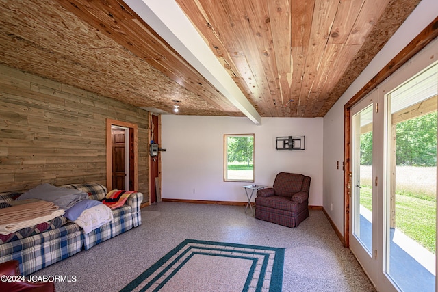 interior space featuring wood walls, beamed ceiling, and wood ceiling