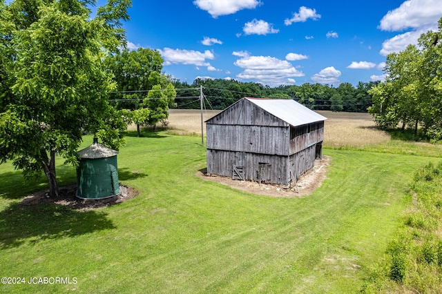 view of outbuilding featuring a lawn