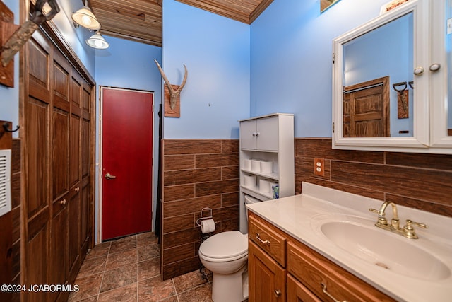 bathroom with vanity, wood ceiling, tile walls, and toilet