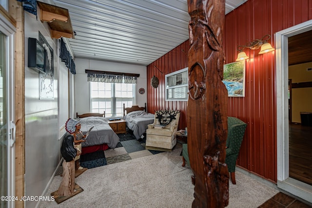 bedroom featuring wooden walls