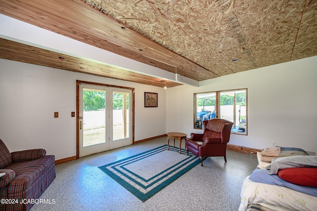 living room featuring plenty of natural light and wooden ceiling