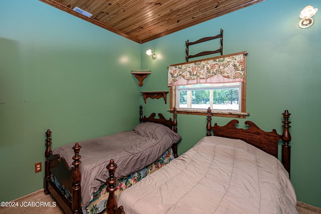 carpeted bedroom with wood ceiling, crown molding, and vaulted ceiling