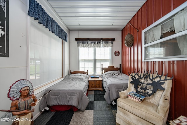 bedroom with wood walls