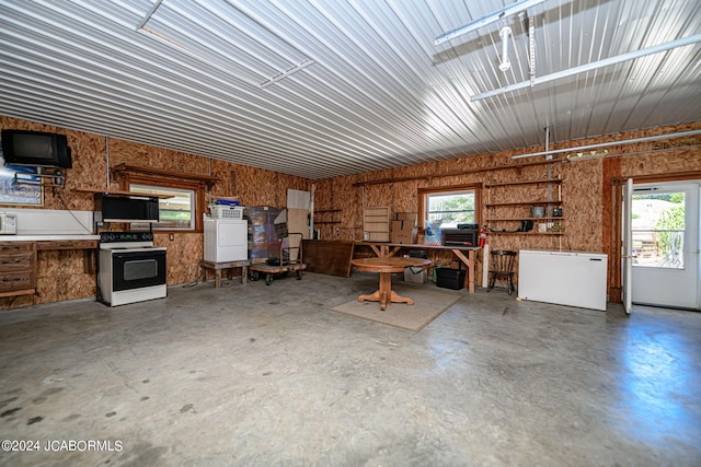 miscellaneous room featuring washer / dryer and concrete floors