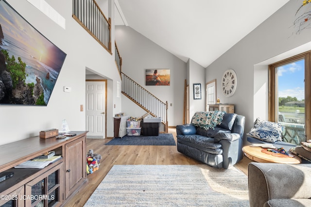 6733 Rocking Horse Ln, Fulton, MO 65251 - living area with stairs, light wood-style floors, and high vaulted ceiling
