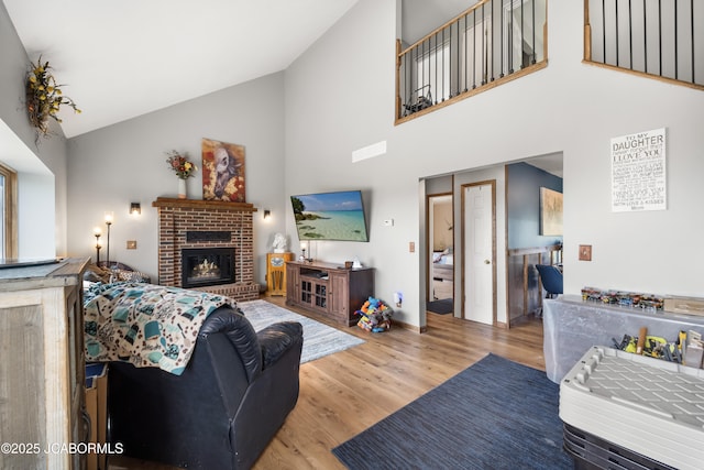 6733 Rocking Horse Ln, Fulton, MO 65251 - living room featuring high vaulted ceiling, wood finished floors, a brick fireplace, and baseboards