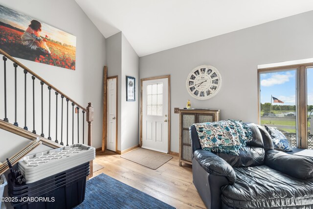 6733 Rocking Horse Ln, Fulton, MO 65251 - living room with lofted ceiling, light wood-type flooring, stairs, and baseboards