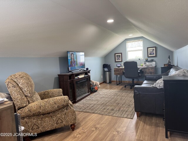 6733 Rocking Horse Ln, Fulton, MO 65251 - office area featuring wood finished floors, vaulted ceiling, and a textured ceiling
