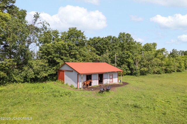 6733 Rocking Horse Ln, Fulton, MO 65251 - view of pole building with a yard and a forest view