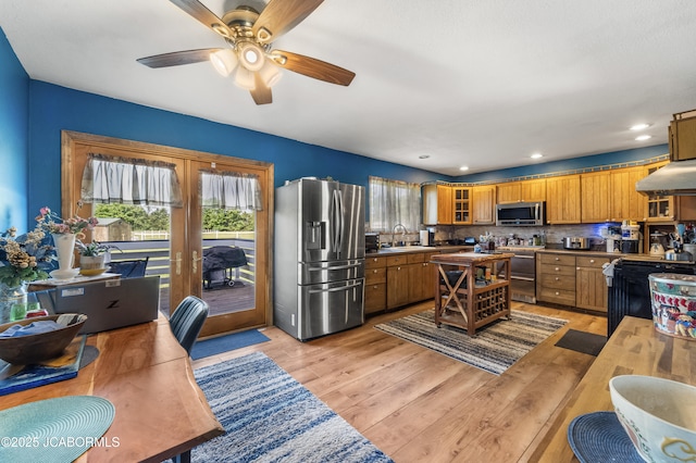 6733 Rocking Horse Ln, Fulton, MO 65251 - kitchen with appliances with stainless steel finishes, a sink, extractor fan, a ceiling fan, and light wood finished floors