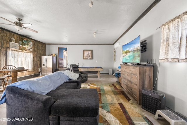 6733 Rocking Horse Ln, Fulton, MO 65251 - living area featuring billiards, wood walls, ceiling fan, crown molding, and a textured ceiling