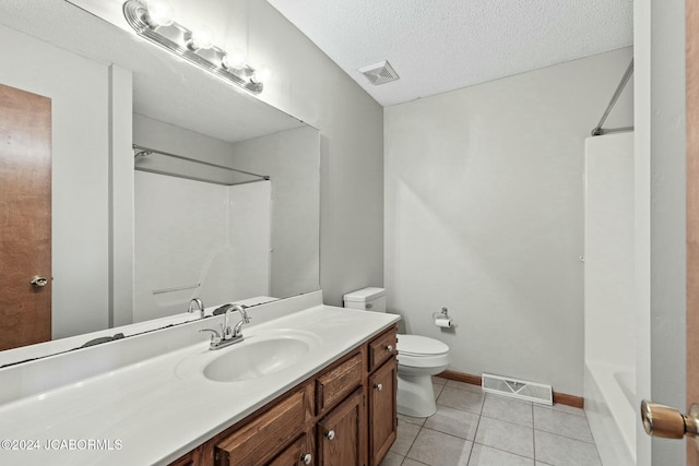 full bathroom with tile patterned flooring, a textured ceiling, toilet, shower / tub combination, and vanity