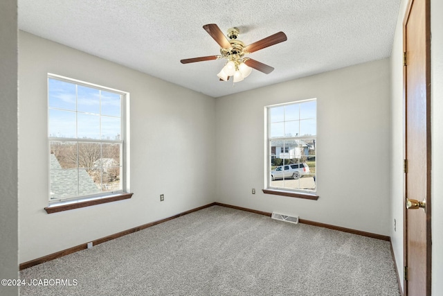 unfurnished room with light carpet, a textured ceiling, and ceiling fan