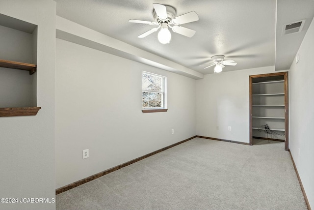 unfurnished bedroom with light colored carpet and ceiling fan