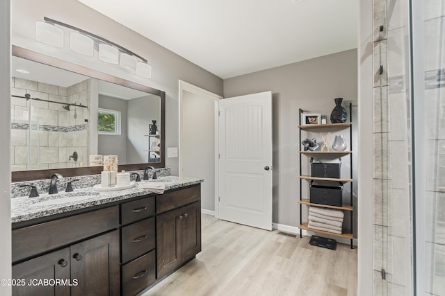 1330 Summerfield Dr, Jefferson City, MO 65109 - full bath with double vanity, wood finished floors, and a stall shower