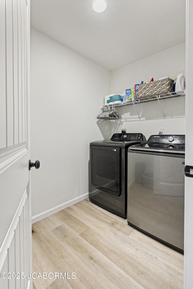 1330 Summerfield Dr, Jefferson City, MO 65109 - washroom featuring washer and clothes dryer and wood finished floors