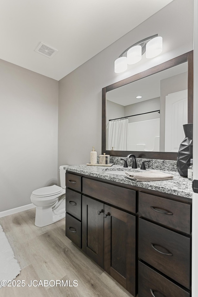 1330 Summerfield Dr, Jefferson City, MO 65109 - bathroom with wood finished floors, vanity, and curtained shower