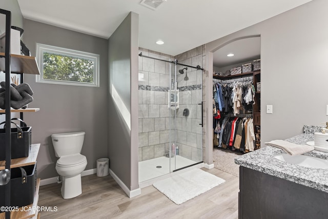 1330 Summerfield Dr, Jefferson City, MO 65109 - bathroom featuring double vanity, a stall shower, wood finished floors, and recessed lighting