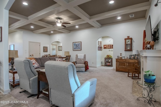 living room featuring crown molding, ceiling fan, coffered ceiling, light colored carpet, and beamed ceiling