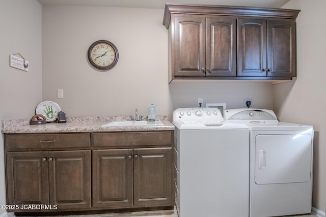 laundry area with cabinets, sink, and washing machine and clothes dryer