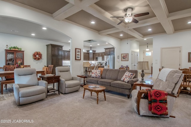 living room featuring coffered ceiling, ceiling fan, light carpet, and beamed ceiling