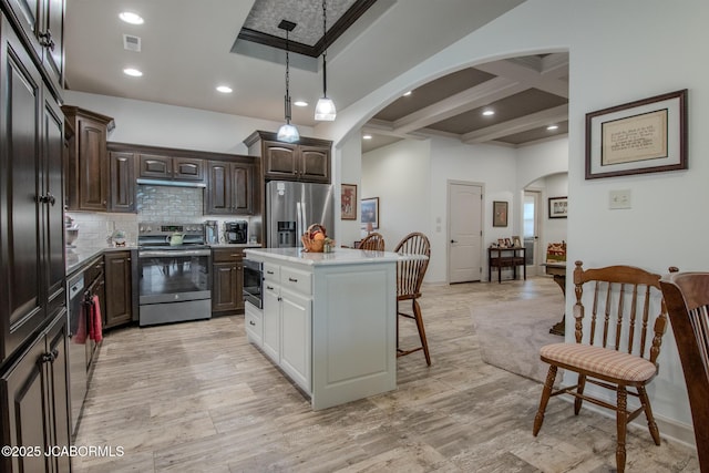 kitchen featuring a kitchen bar, coffered ceiling, dark brown cabinets, a kitchen island, and stainless steel appliances