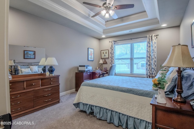 bedroom with ceiling fan, light colored carpet, ornamental molding, and a tray ceiling