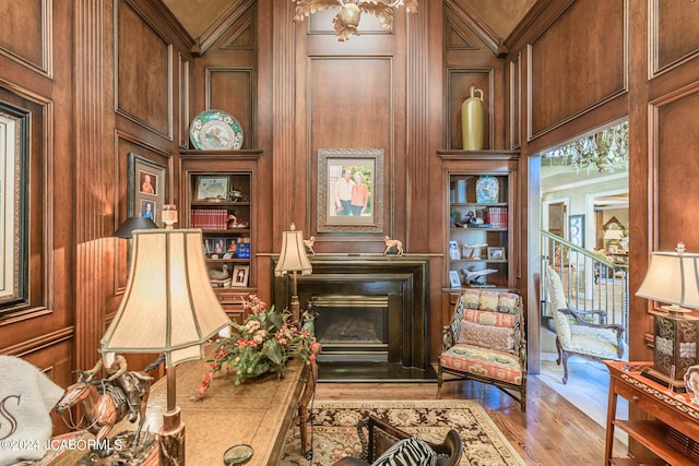 sitting room with built in features and light wood-type flooring