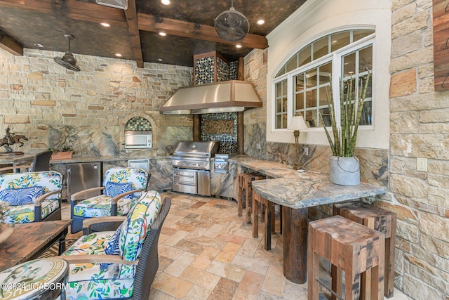 kitchen featuring refrigerator and ventilation hood