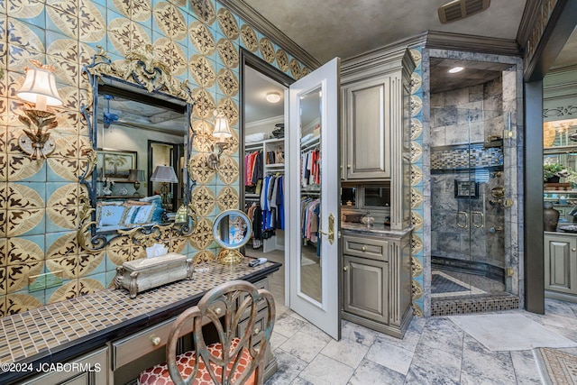 bathroom featuring crown molding, vanity, and an enclosed shower