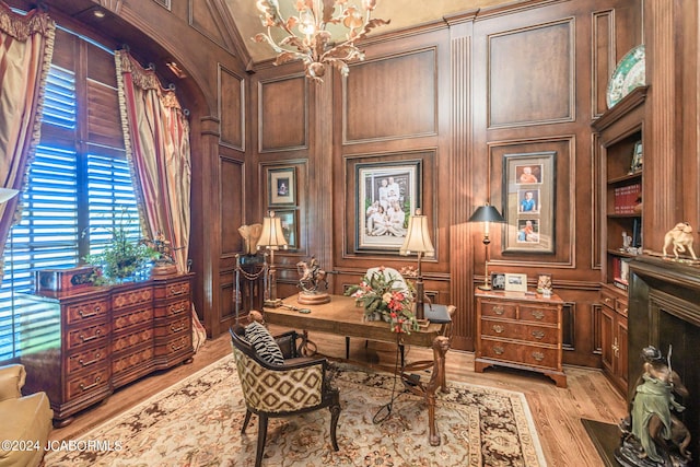 office featuring a chandelier, light hardwood / wood-style floors, and lofted ceiling