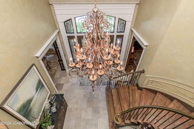 entrance foyer featuring a chandelier and a high ceiling