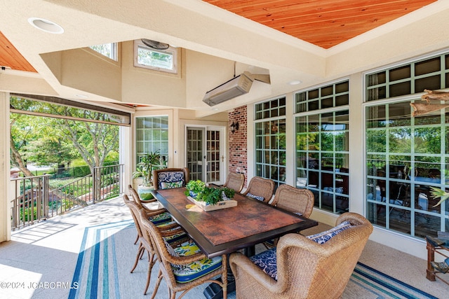 sunroom featuring wood ceiling and french doors