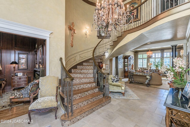 staircase featuring a towering ceiling and ornamental molding