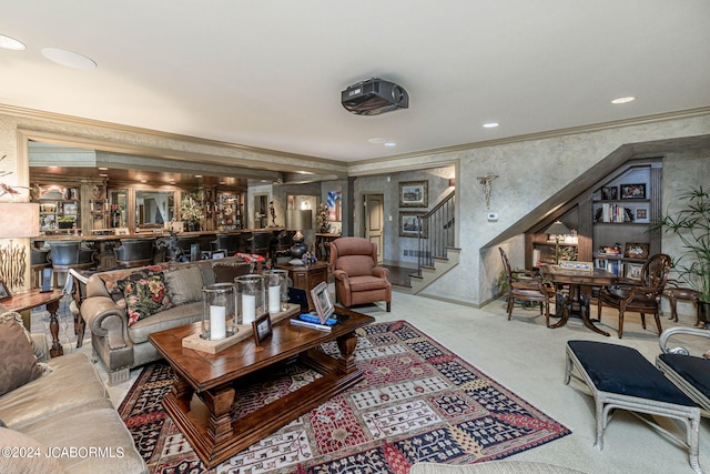 carpeted living room with bar and crown molding