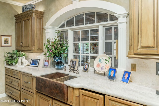 kitchen featuring decorative columns and sink