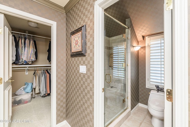 bathroom with tile patterned flooring, toilet, crown molding, and walk in shower