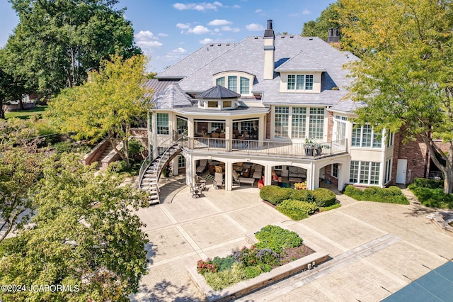 rear view of property with a balcony