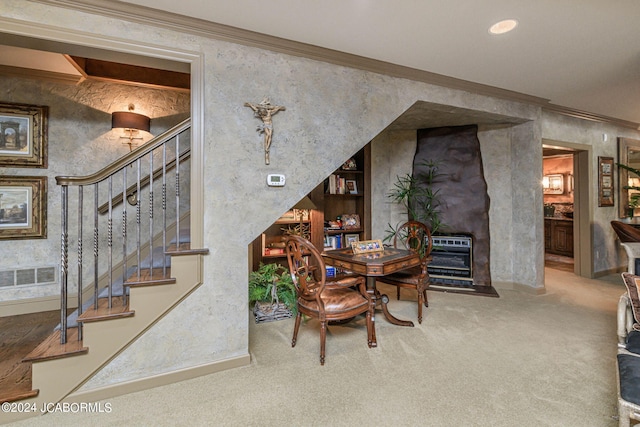 carpeted dining room with crown molding and heating unit