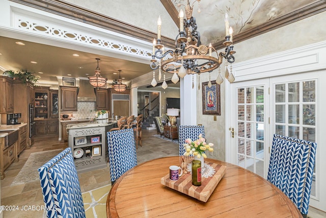 dining room with crown molding and a chandelier