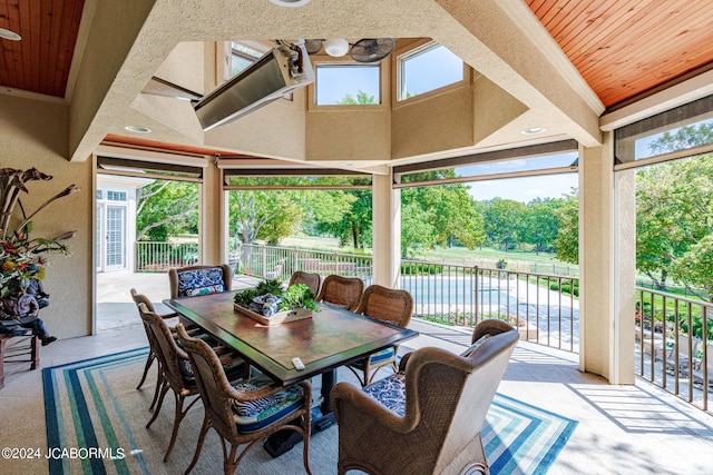 sunroom / solarium featuring wood ceiling