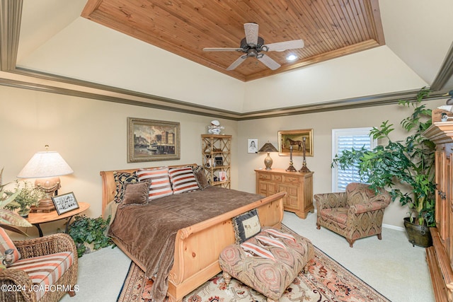 carpeted bedroom with a tray ceiling, ceiling fan, ornamental molding, and wood ceiling