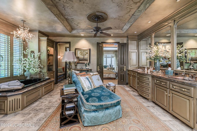 bathroom featuring a raised ceiling, crown molding, vanity, and ceiling fan with notable chandelier