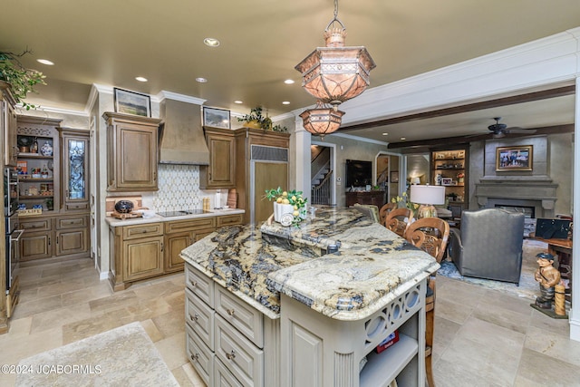 kitchen featuring ceiling fan, a center island, crown molding, black electric stovetop, and custom range hood