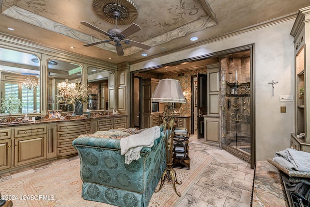 living area featuring a tray ceiling, ceiling fan, and ornamental molding