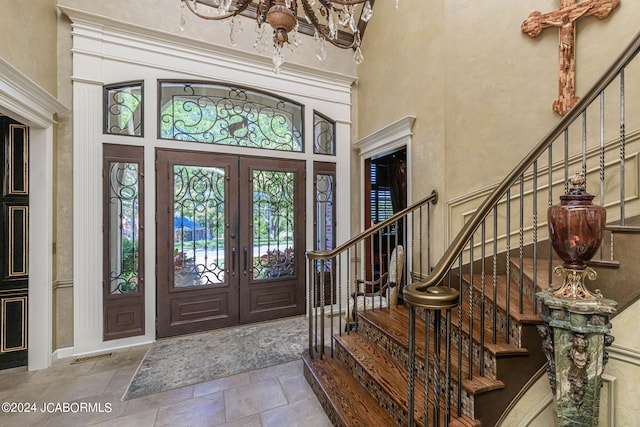 foyer entrance featuring a high ceiling and french doors