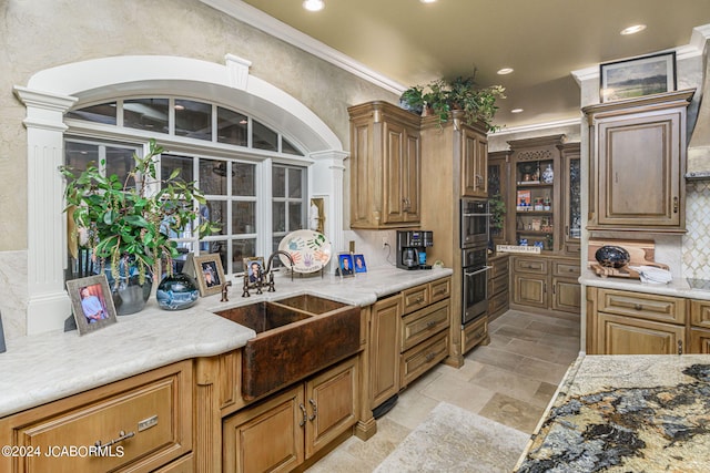 kitchen with backsplash, sink, and ornamental molding